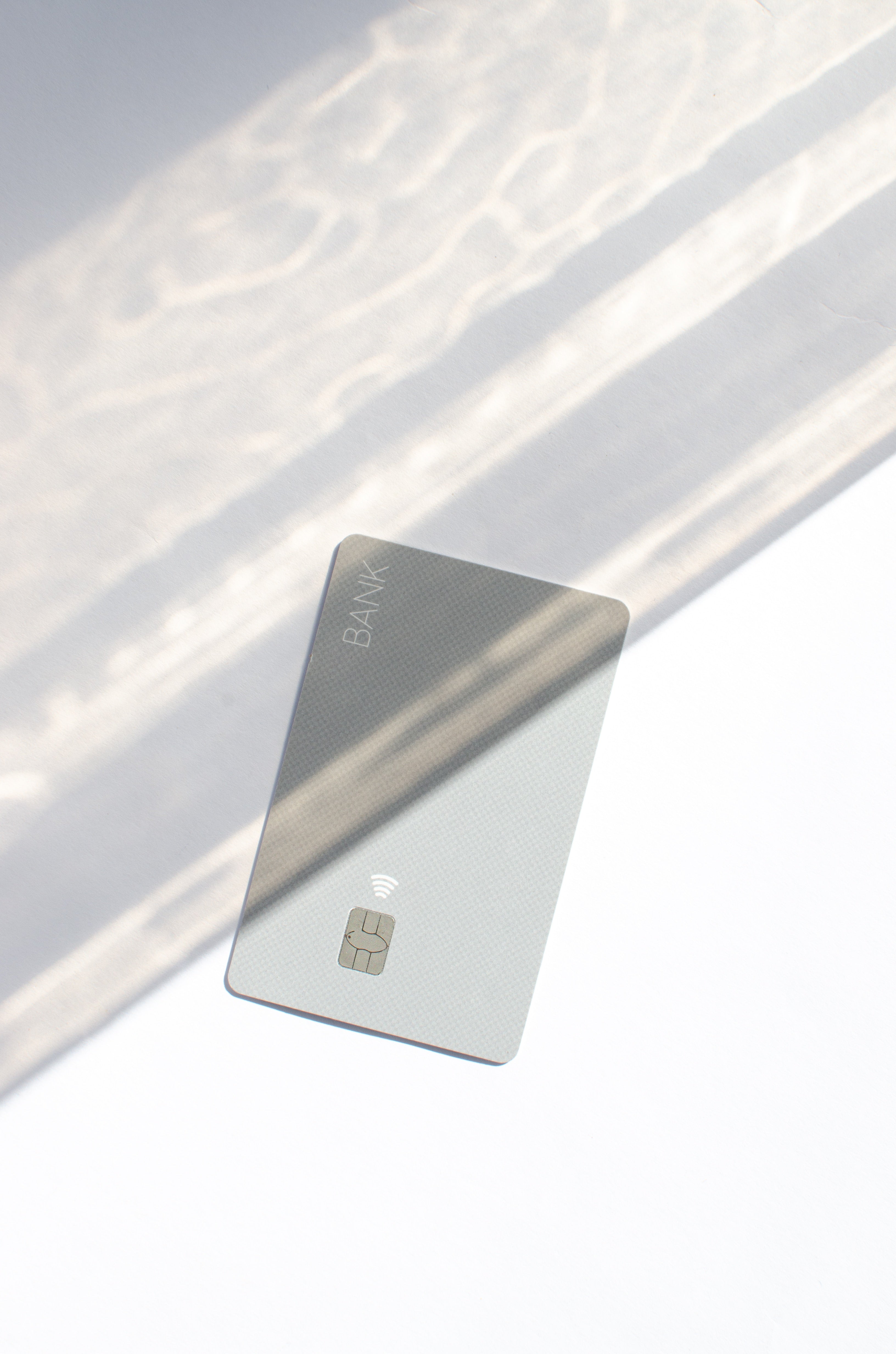 Grey credit card representing online payments and no prepayment